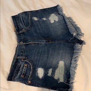 High-waisted cheeky dark wash shorts with rips